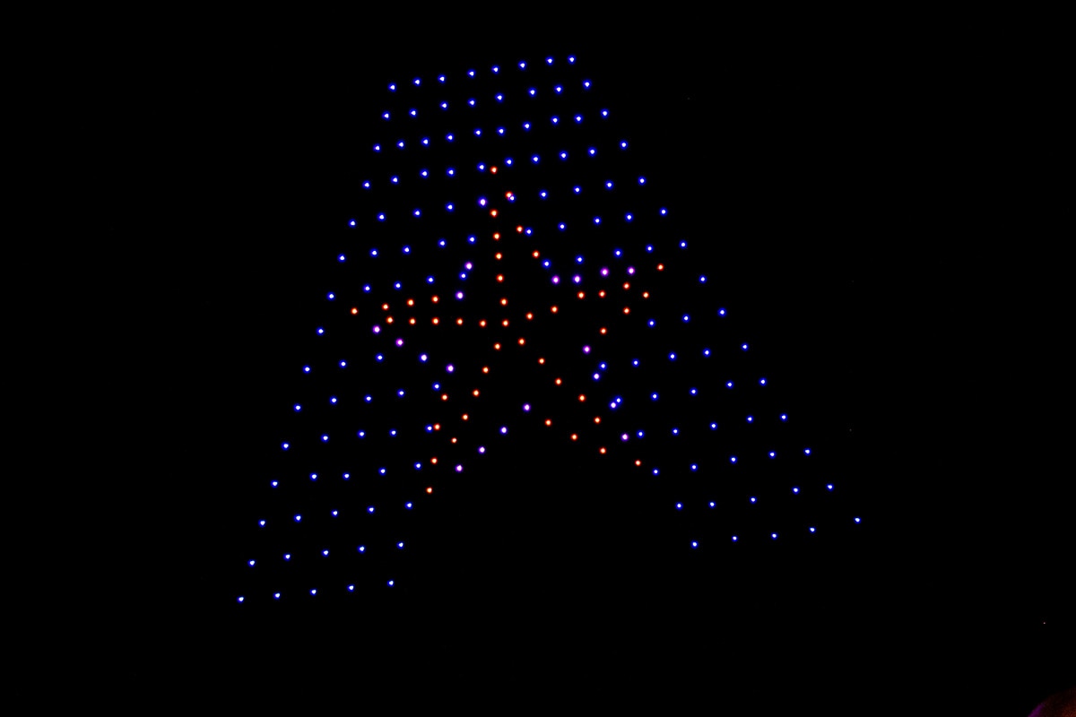 Drones against the night sky with lights creating the UTA logo - opens in a new tab